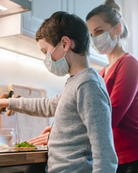 Mother and son cooking at home during the crisis time
