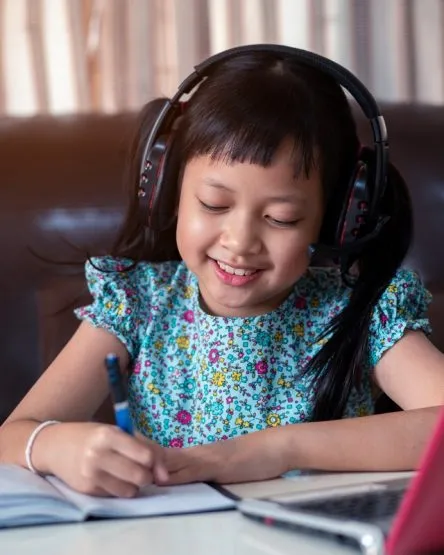 Cute asian little child girl studying online lesson at home, so