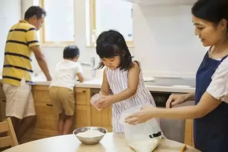 Family home. Two parents and two children preparing a meal. ,Family,Japan