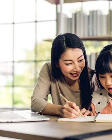 Mother and asian kid little girl learning and looking at laptop