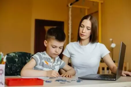 A mother and her child are engaged in distance learning at home in front of the computer. Stay at home, training.