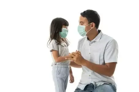 worried father and daughter wearing face mask