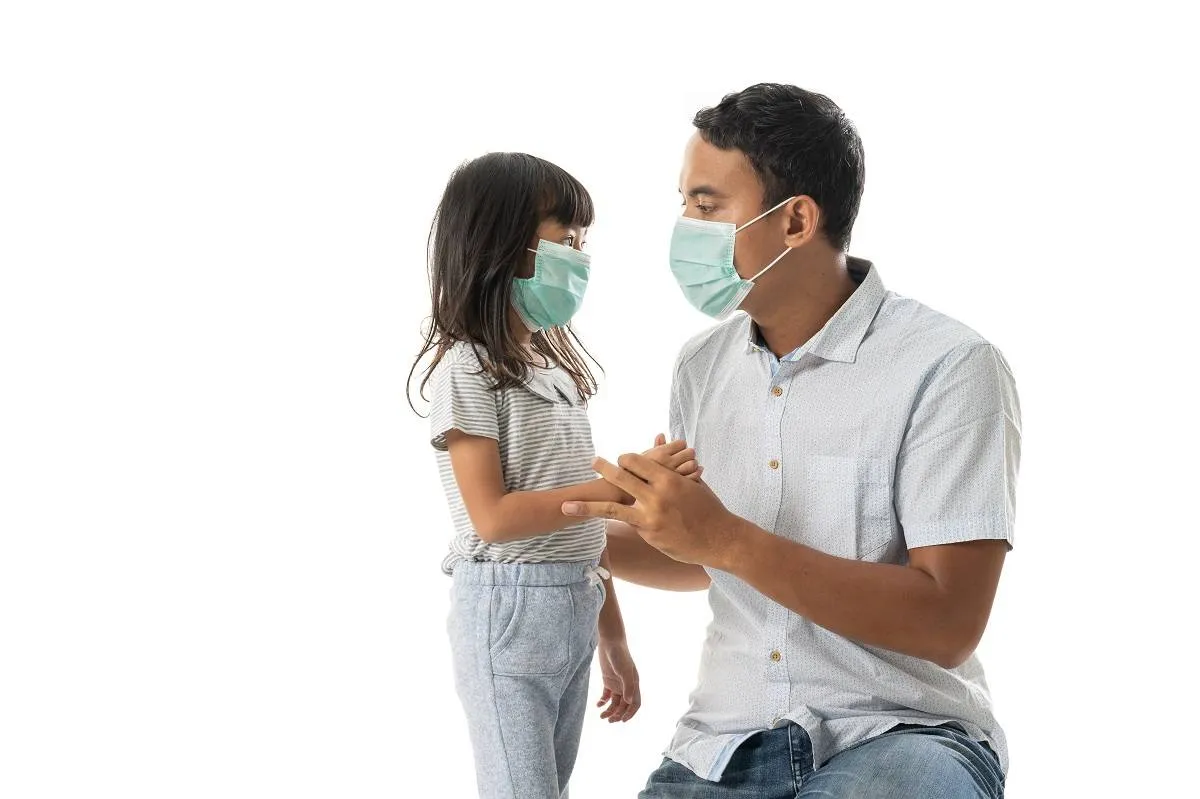 worried father and daughter wearing face mask